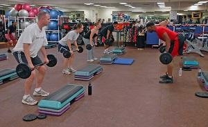 A group of people performing strength training exercises